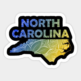 Colorful mandala art map of North Carolina with text in blue and yellow Sticker